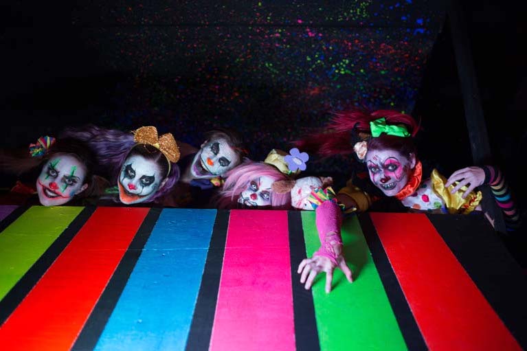 Clowns crawling up from behind a rainbow floor at The Haunted Hotel, California