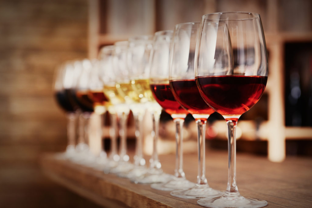 Row of glasses of red and white wine