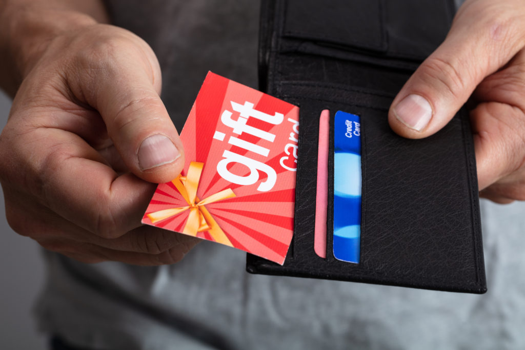 Person removing a gift card from their wallet