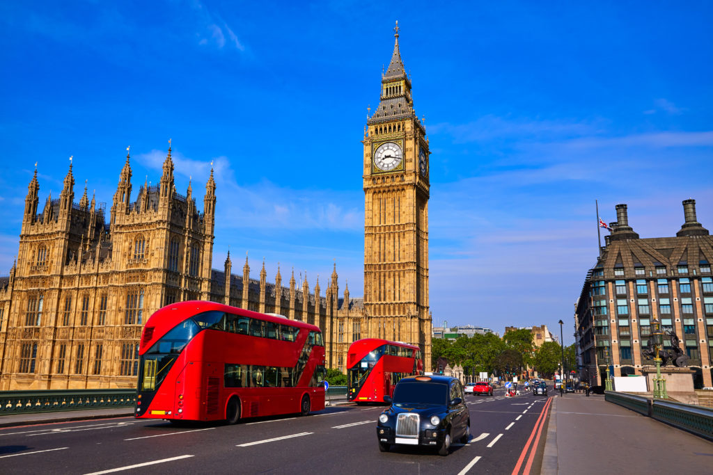 London bus in front of Big Ben Clock Tower in London, England