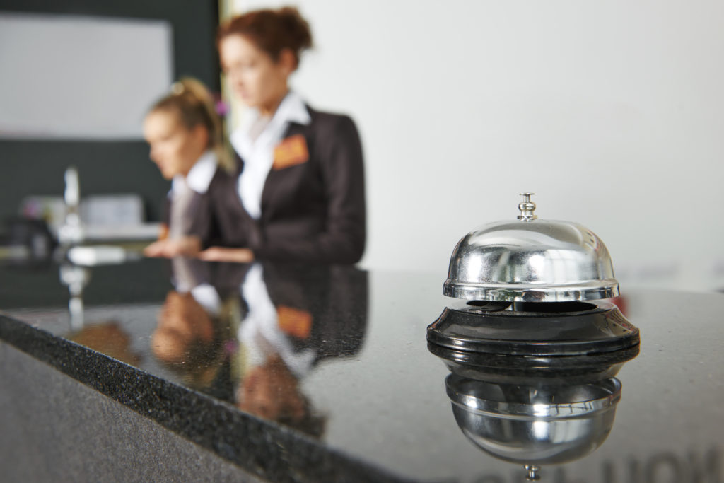 Two women working at concierge desk at hotel