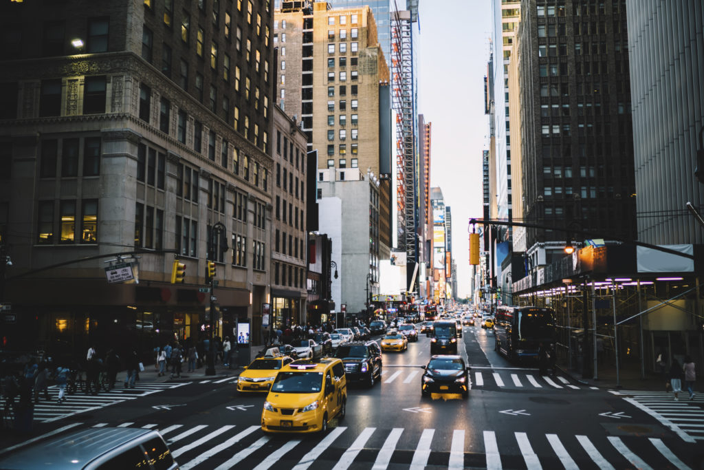 Street view of people crossing street in Midtown Manhattan, New York City, United States
