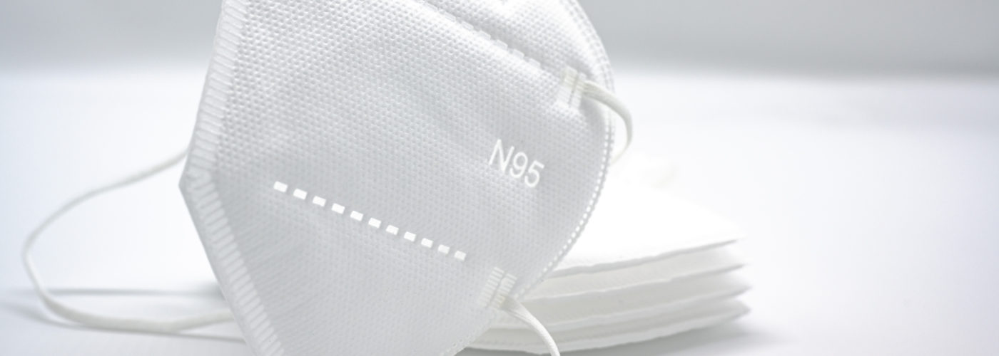 Stack of white N95 masks on a white background