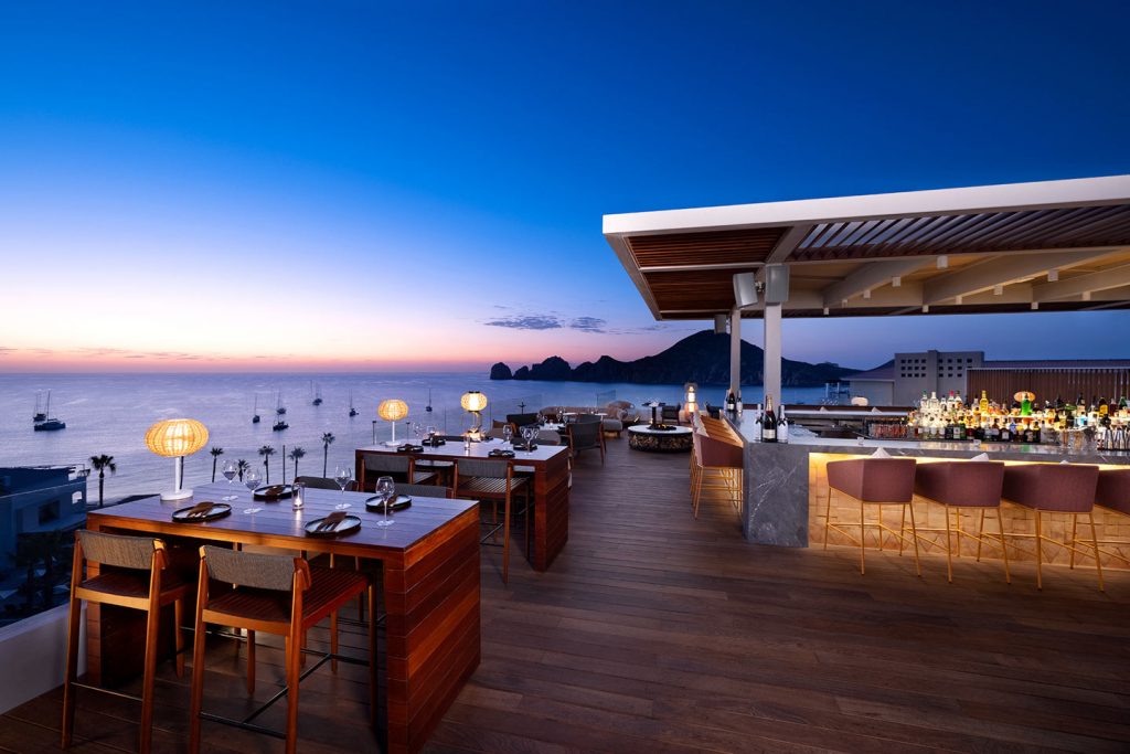 Patio and bar area overlooking the ocean at ME Cabo
