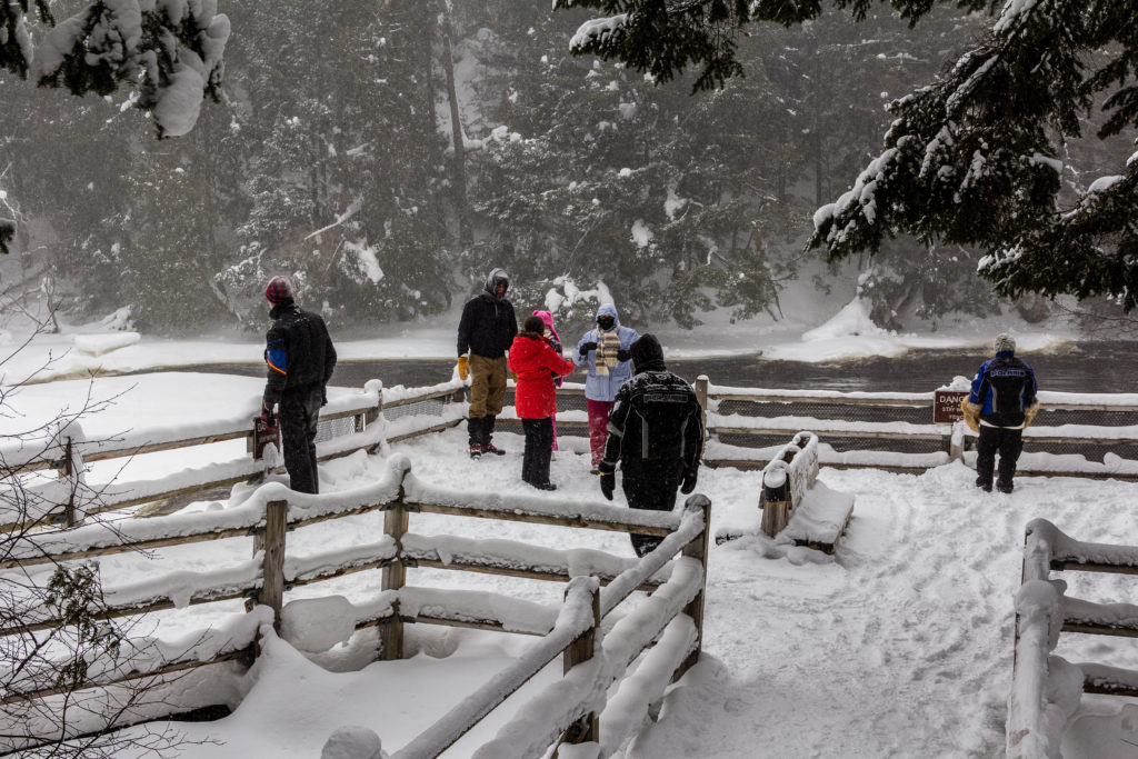 Group of people walking on snowy trails in Tahquamenon Falls State Park, Michigan