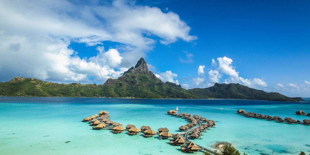 Overwater bungalows with mountainous landscape in the background at the InterContinental Bora Bora