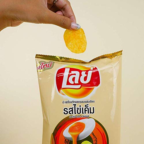A hand taking a chip out of a tan bag of Lay’s Salted Egg Flavor chips