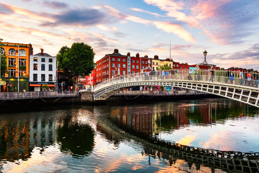 Row of colorful houses and bridge over water in Ireland