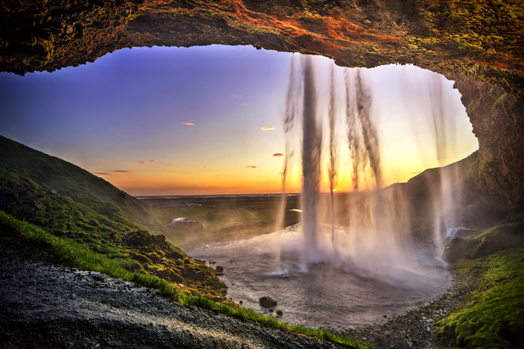 Sunset as seen from a cave behind a waterfall in Iceland