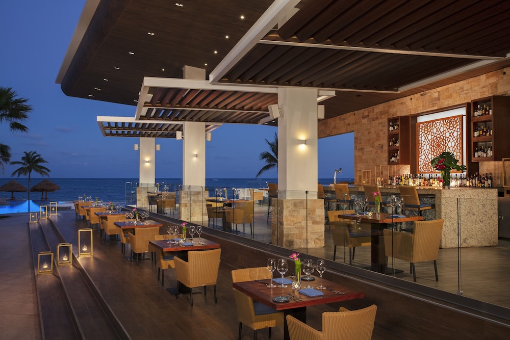 Outdoor dining by the ocean at Secrets Maroma Beach Riviera Cancún Resort & Spa Adults-Only All-Inclusive, Cancún, Mexico