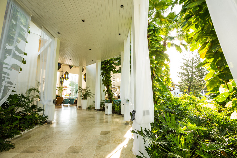 Walkway surrounded by white curtains and greenery at BlueBay Villas Doradas Adults-Only All-Inclusive, Puerto Plata, Dominican Republic