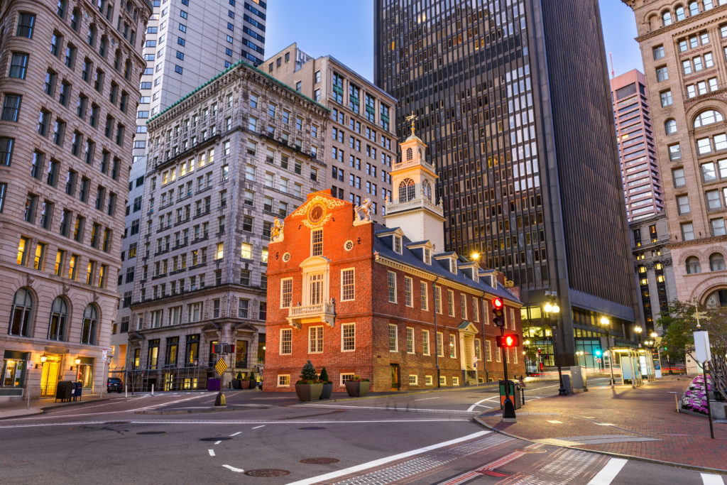The Old State House in Boston, Massachusetts surrounded by new city buildings and roads