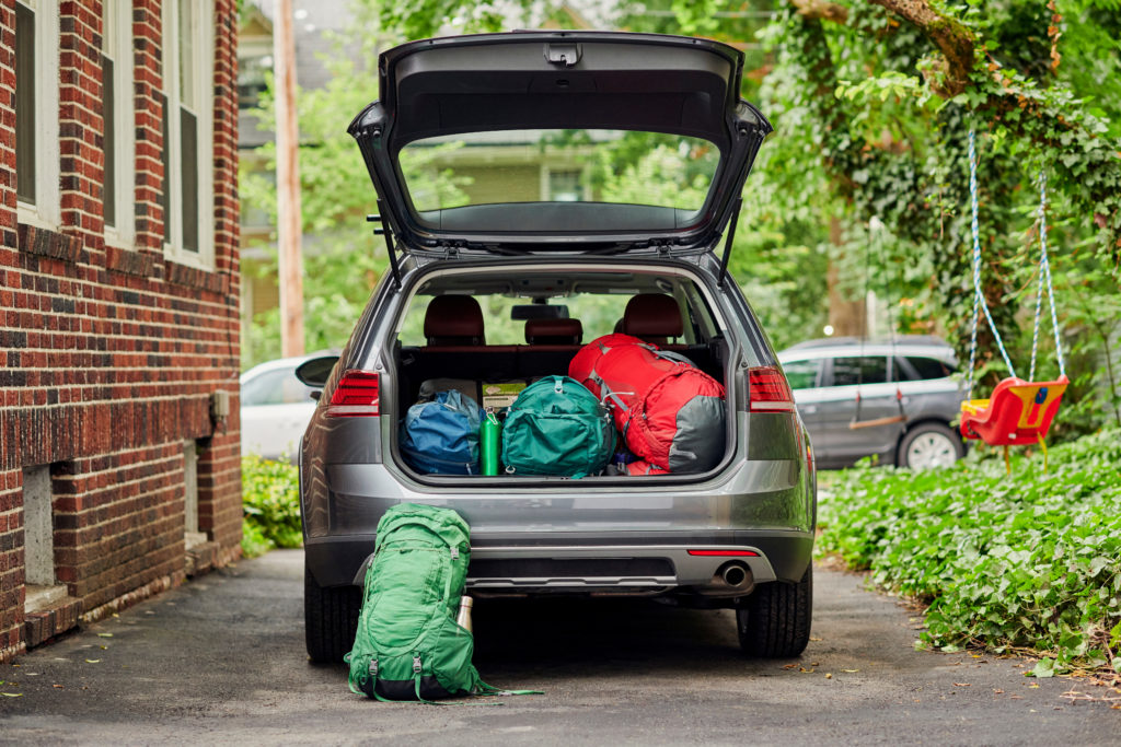 A car packed up with luggage in preparation for a road trip