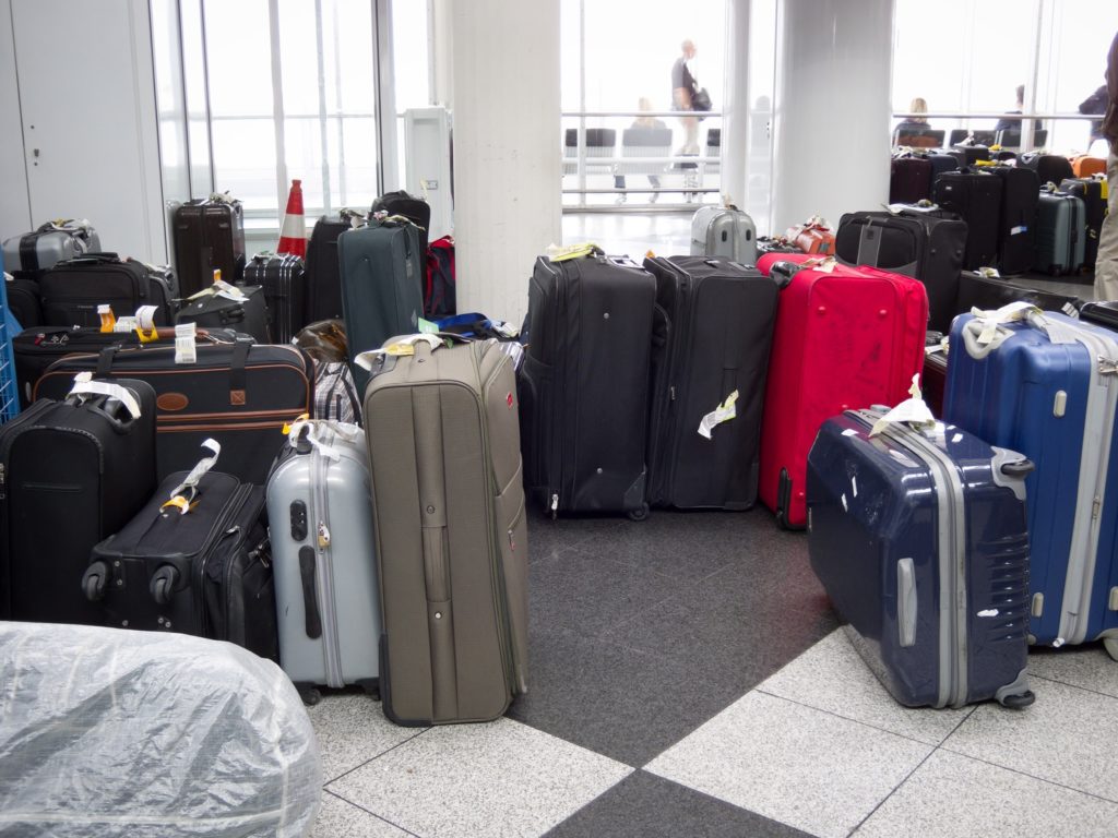 Luggage gathered on the airport floor near baggage claim