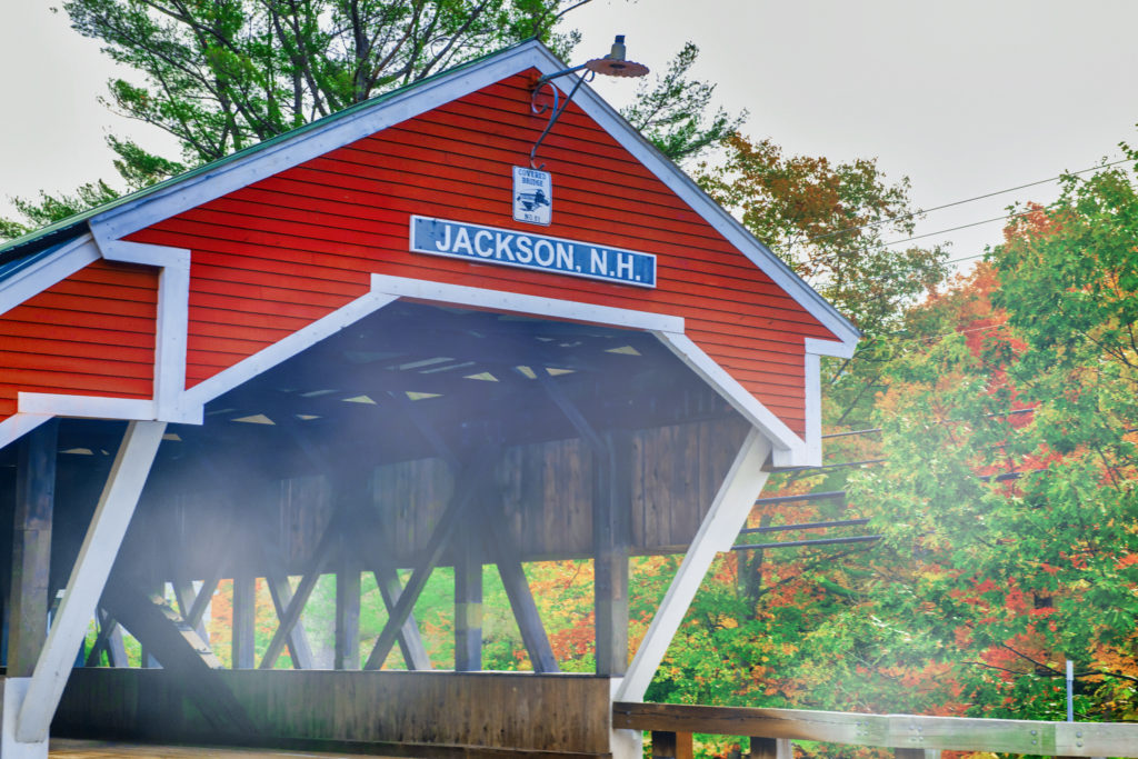 Covered bridge in Jackson, New Hampshire surrounded by early fall foliage