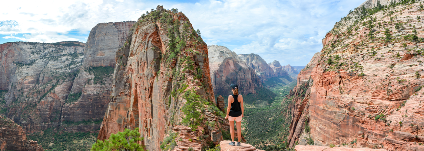Woman standing on ledge in Zion National Park