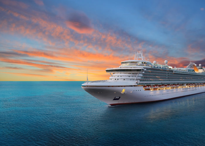 Cruise ship sailing at sunset