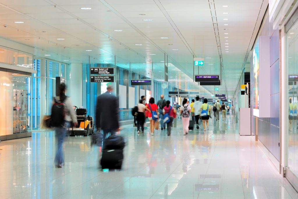People walking in blurry motion through an airport
