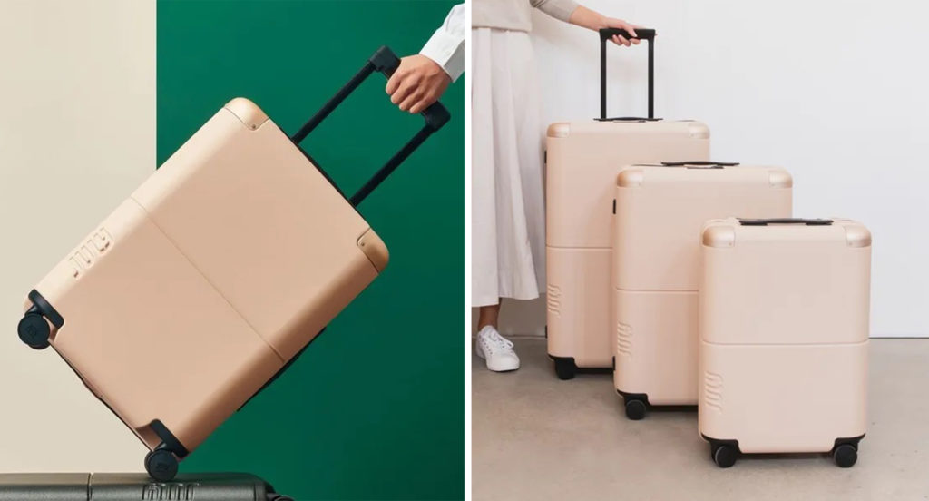 Close up of person pulling a July Carry On (left) and a set of July luggage in pink (right)