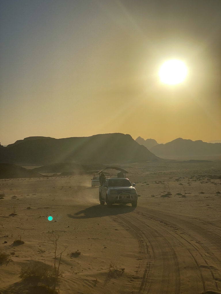 Hooded trucks running through the desert in Wadi Rum, Jordan