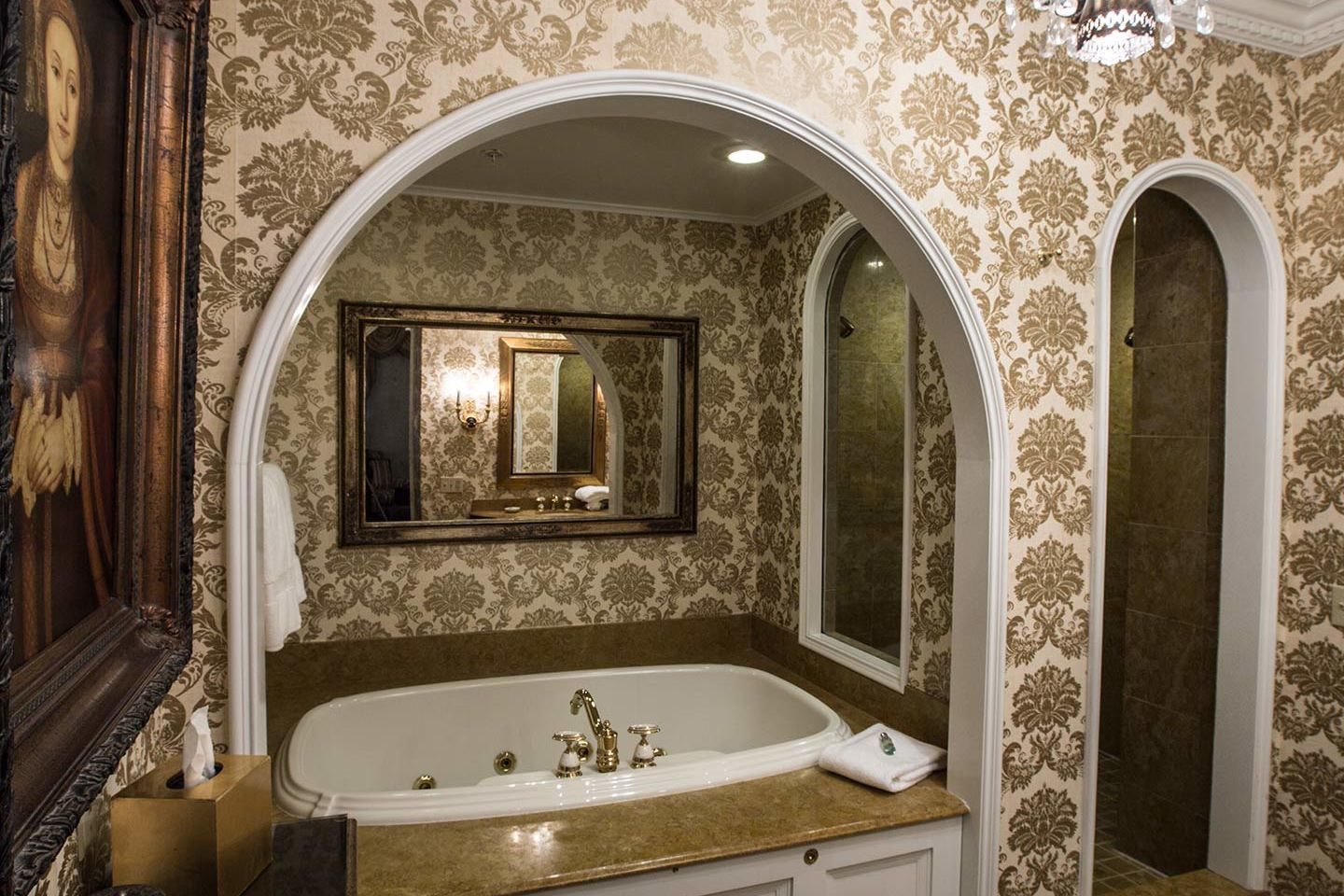 Gold, floral bathroom and bath tub at The Chanler at Cliff Walk, Rhode Island