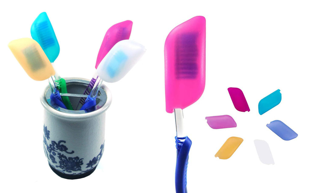Multicolored silicone toothbrush covers on several toothbrushes
