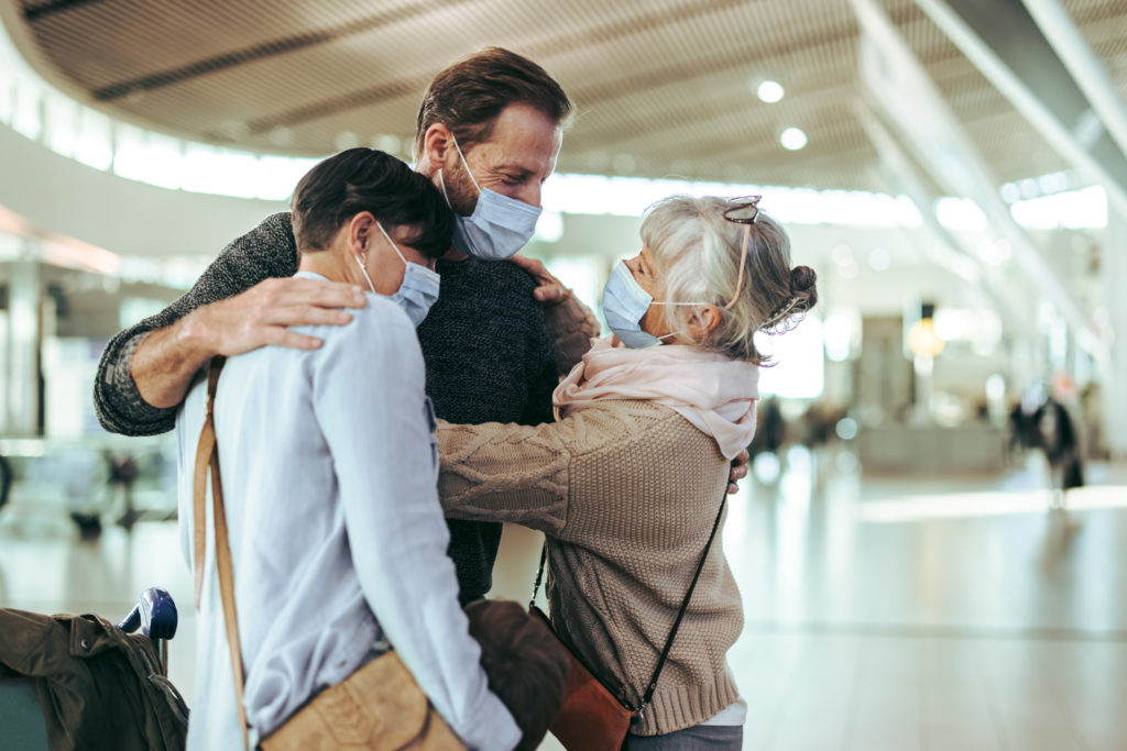 Elderly person greeting her family at the airport