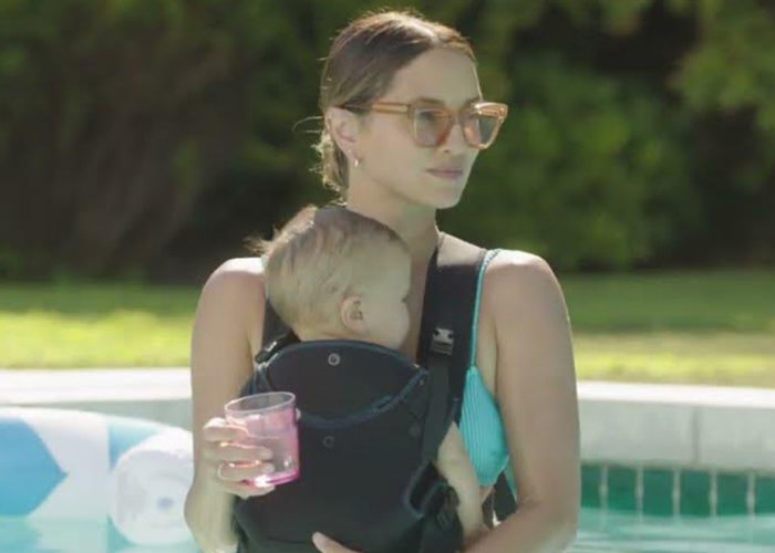 Mom carrying baby in pool in Aquaroo baby carrier