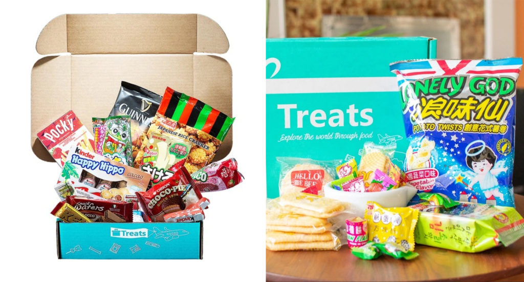 Various treats and snacks surrounding the packaging of the Treats snack subscription box