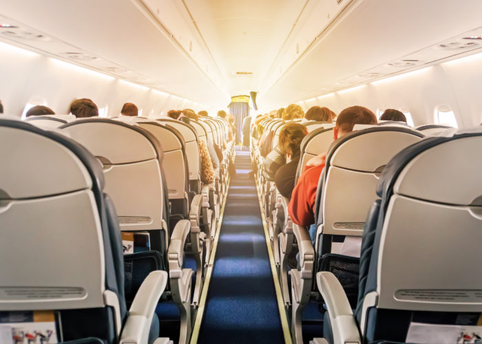 View of a full plane cabin from the back