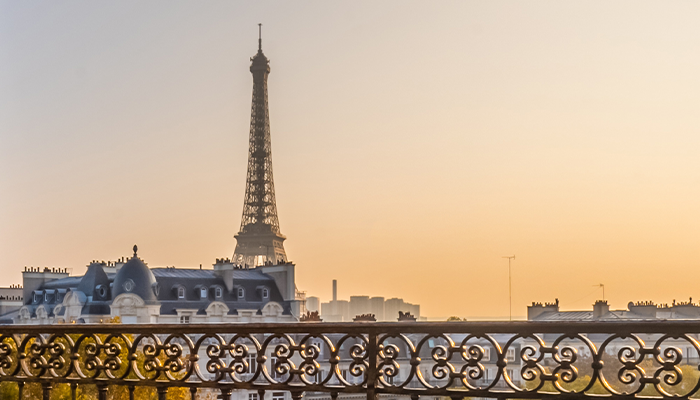 View of the Eiffel Tower from a Parisian balcony at sunset